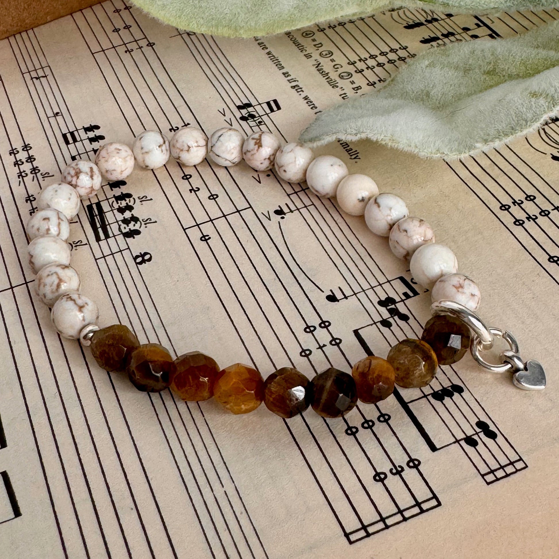 white magnesite with faucet tiger eye beads in 6mm also includes a sterling silver heart charm